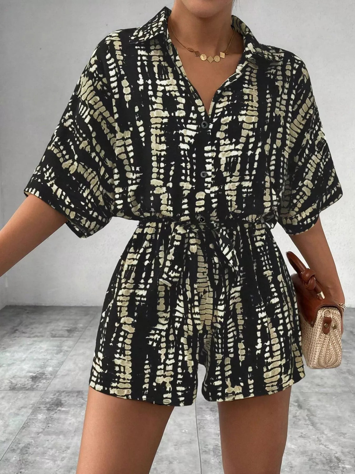 Striped button-up belted romper jumpsuit by Plush Fashion Hub, featuring a stylish design with a collar and waist tie.
