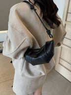 Croissant-shaped crossbody bag by Trendsi featuring a soft, detailed croissant design with a strap for easy carrying.
