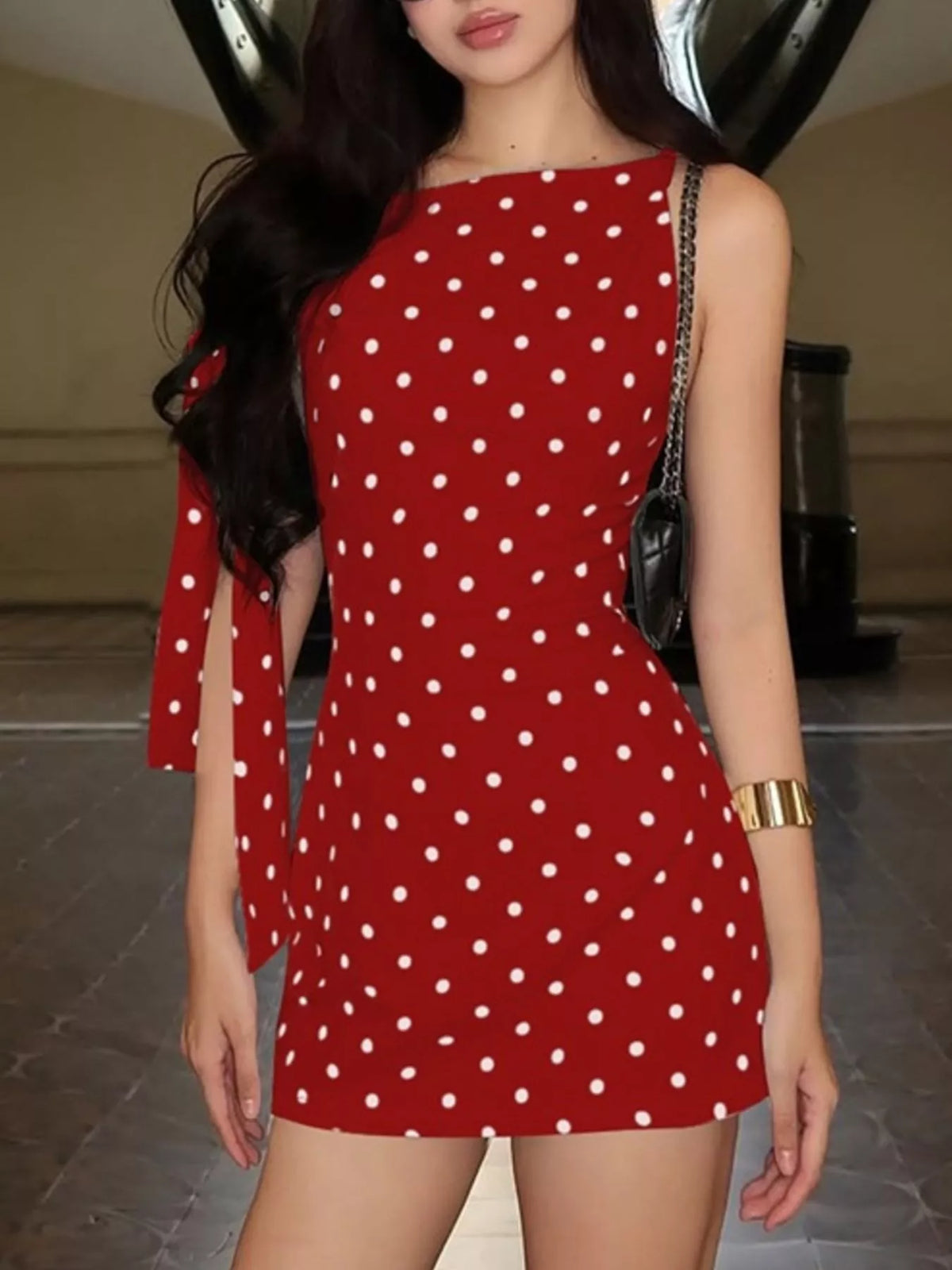 Polka dot sleeveless mini dress with bow accents by Plush Fashion Hub, featuring a fitted silhouette and playful design.