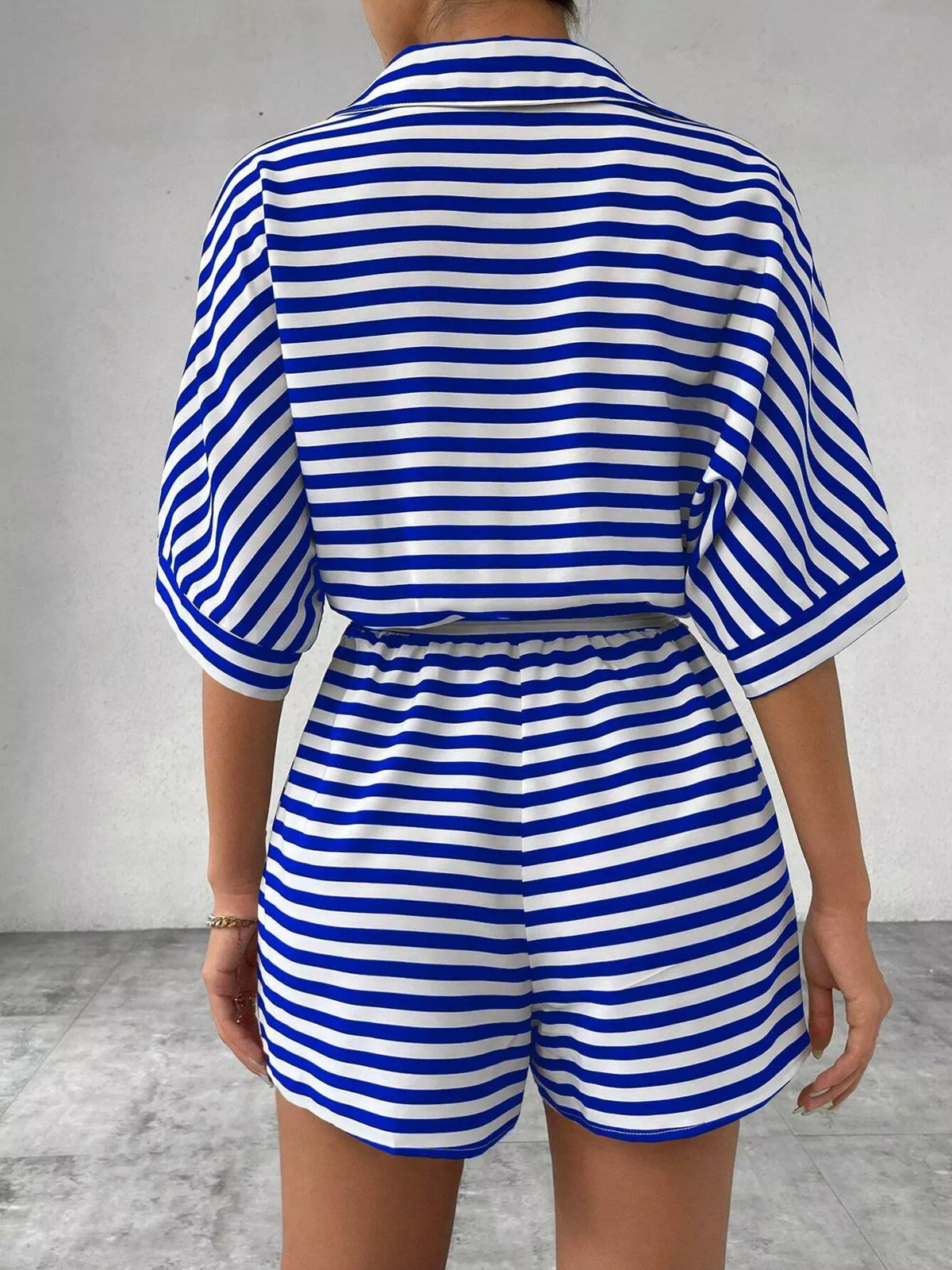 Striped button-front half sleeve romper shirt by Plush Fashion Hub, featuring a casual design and front button closure.