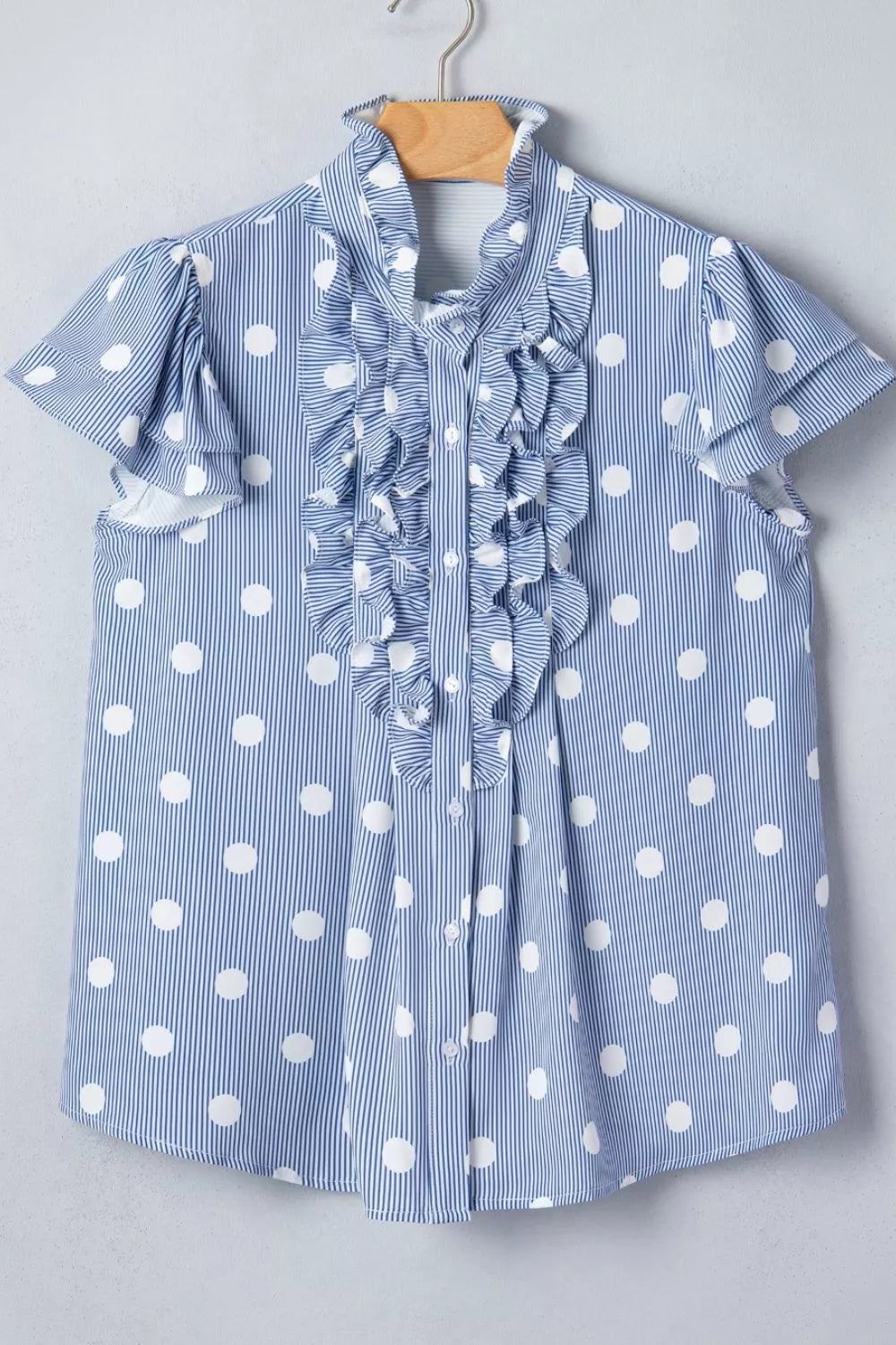 Plush Fashion Hub stripe contrast polka dot print pleated ruffle sleeve shirt hanging on a hanger, showing its pattern and design details.