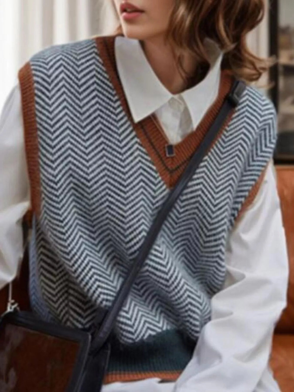 Chevron pattern V-neck knit sweater vest by Trendsi, featuring a stylish design and ribbed trim on a neutral background.