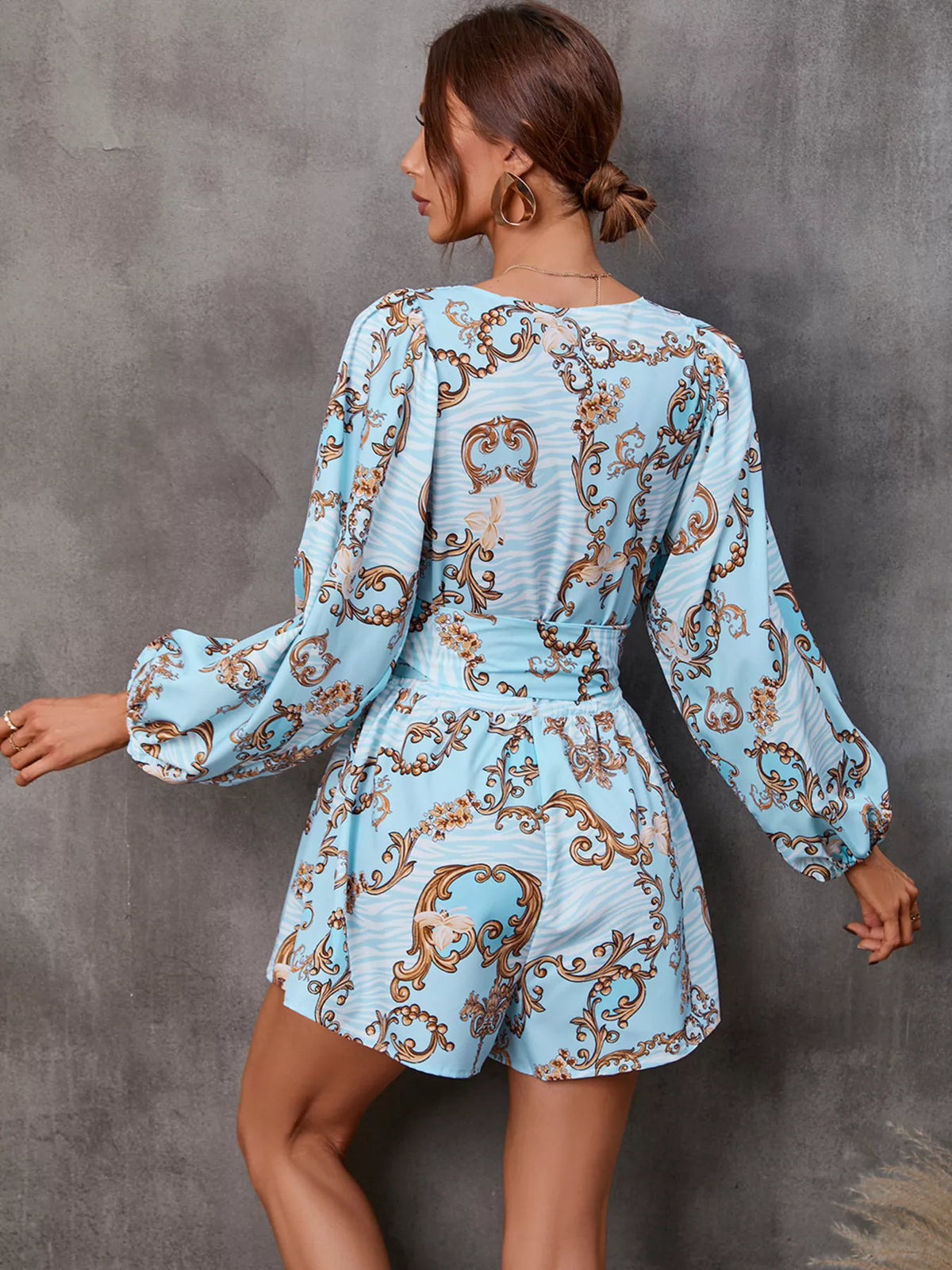 Printed long sleeve romper with front cutout, stylish jumpsuit by Plush Fashion Hub featuring a trendy design and comfortable fit.