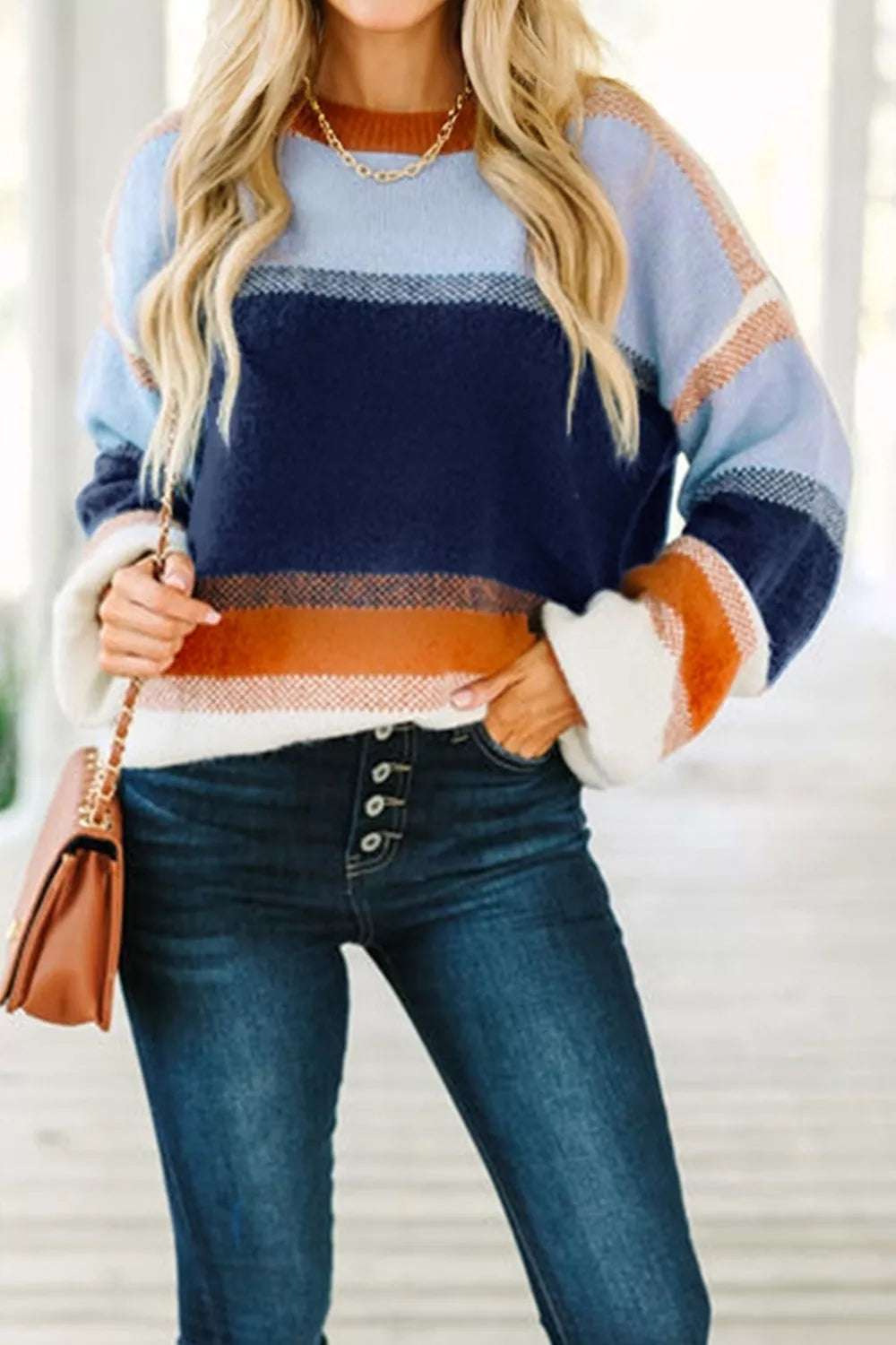 Color block round neck tunic sweater by Trendsi, featuring vibrant color panels and a cozy fit, displayed on a mannequin.