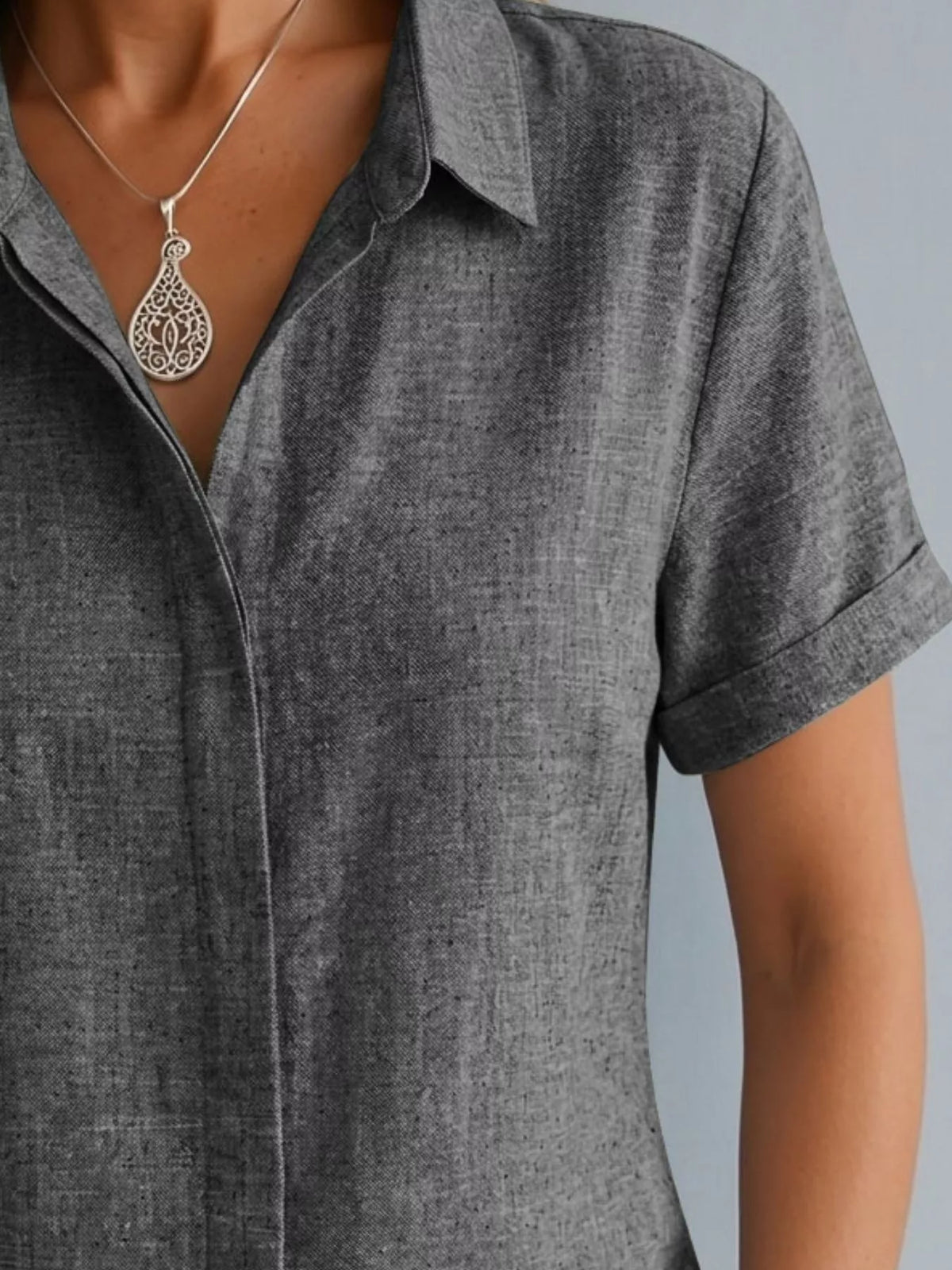 Plus size collared short sleeve shirt from Trendsi, featuring a classic collar and relaxed fit, shown in a full view.