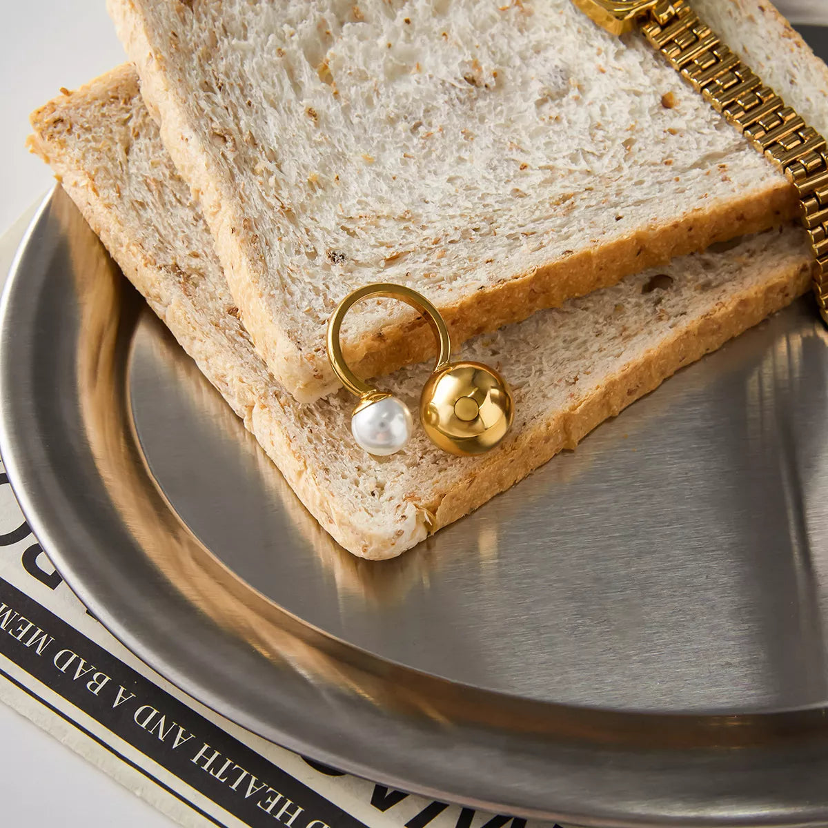 18K gold-plated orb and pearl open ring from Plush Fashion Hub, featuring a circular pearl accent and sleek gold band.