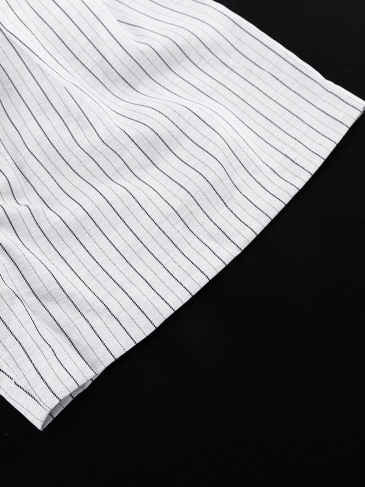 Pinstripe cropped blazer and pleated shorts set by Trendsi, featuring tailored design and stylish pinstripe pattern.