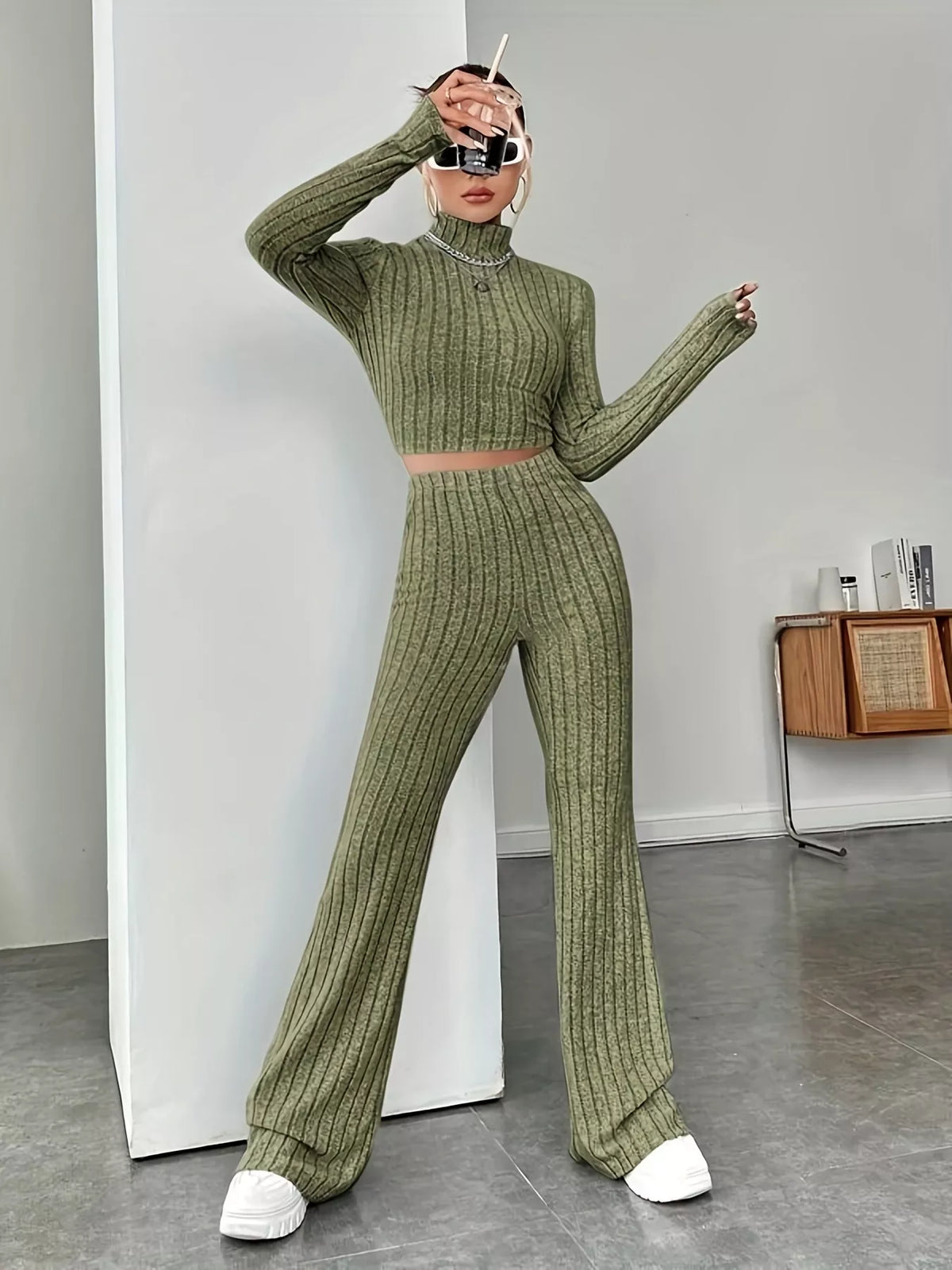 Ribbed turtleneck crop top and flare pants sweater set by Trendsi, featuring a fitted ribbed design and stylish flare pants.