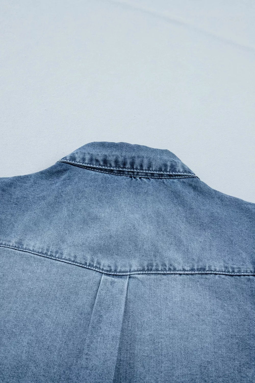 Plush Fashion Hub frilled short sleeve denim shirt with snap buttons, featuring a casual, stylish design and frilled accents.