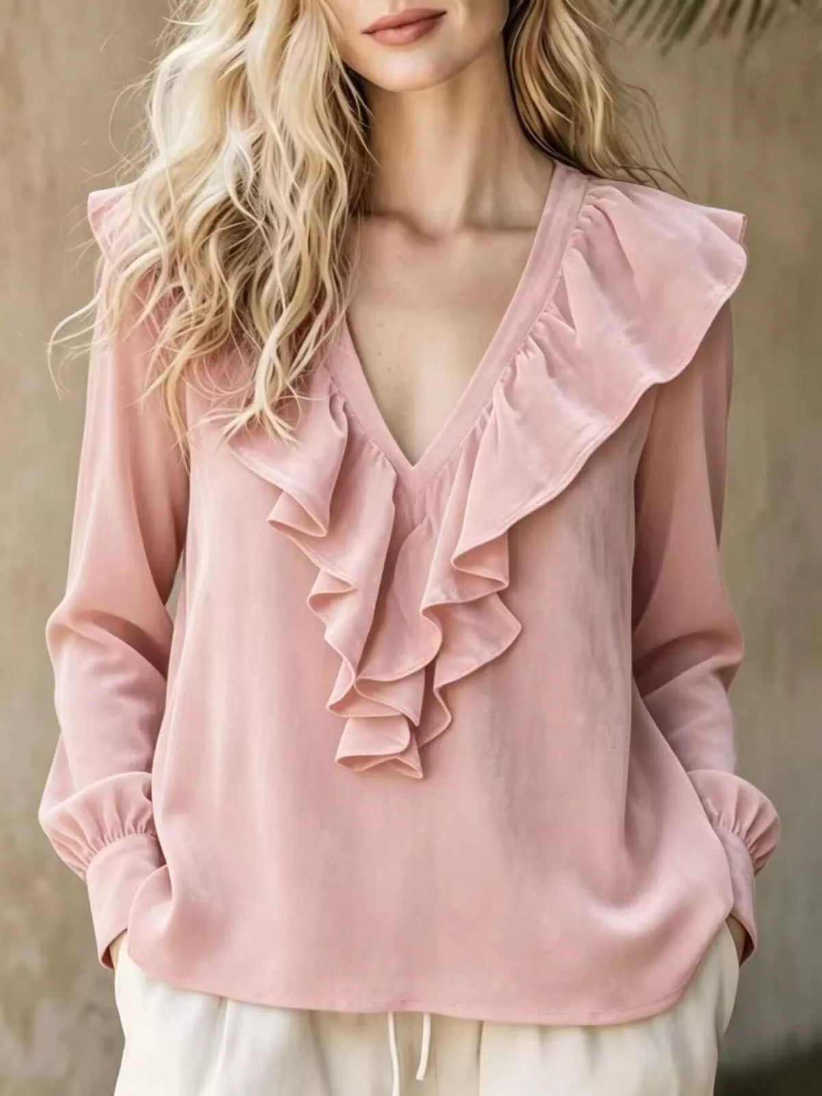 Plus size long sleeve V-neck ruffled blouse from Trendsi, featuring a feminine design and full-size fit, shown in soft fabric details.
