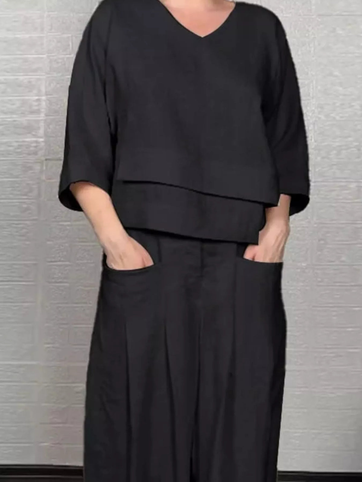Plus size matching set with full V-neck long sleeve top and pants by Trendsi, featuring comfortable, stylish loungewear.
