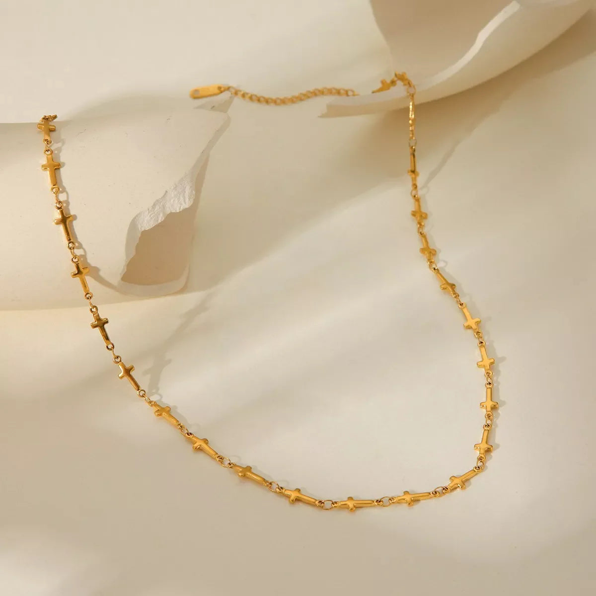 Gold-plated cross necklace from Plush Fashion Hub, featuring a delicate chain and a detailed cross pendant.