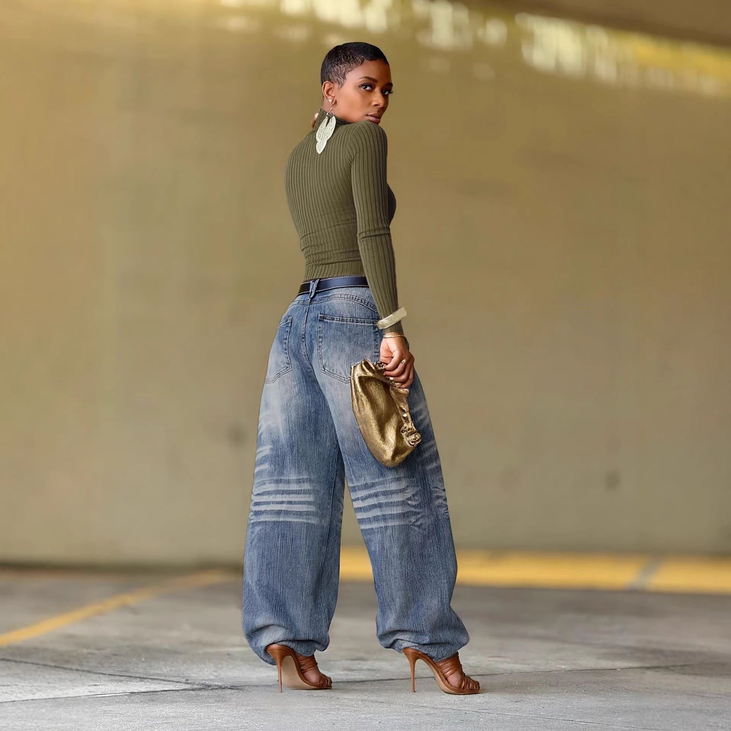 Relaxed fit faded pleated denim jeans by eprolo, showing the distressed light blue fabric with pleats and a relaxed silhouette.