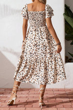 Women's square neck ruffle sleeve smocked midi dress made of cotton blend, featuring a fitted bodice and flowy skirt.