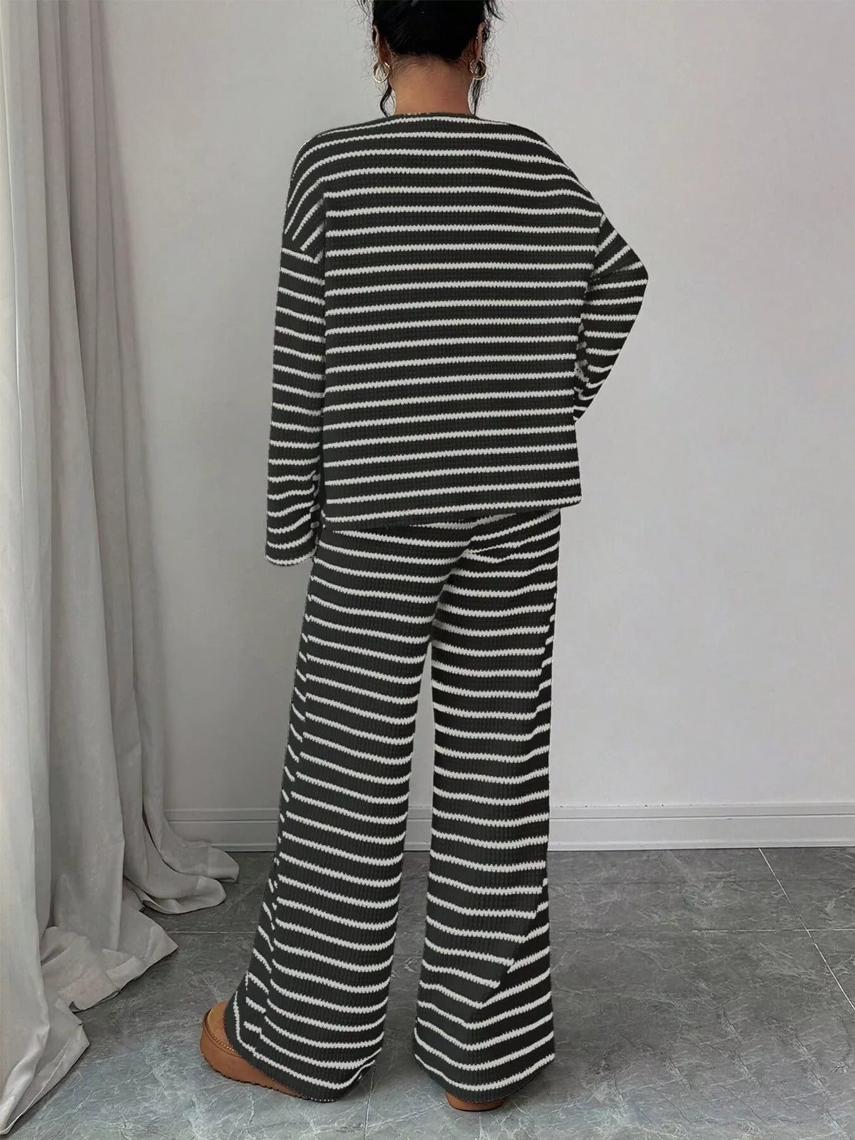 Striped knit dropped shoulder top and pants set by Trendsi, featuring a cozy, stylish matching outfit with bold stripes and relaxed fit.