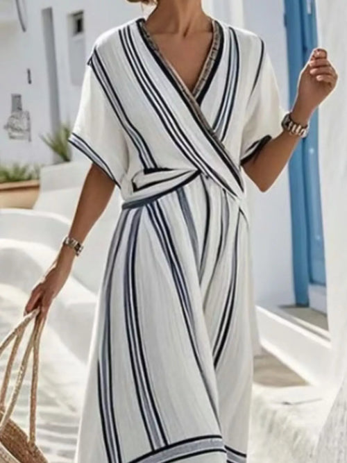 Full size striped short sleeve wrap maxi dress by Trendsi, featuring a stylish pattern and flowing design in a plus size fit.