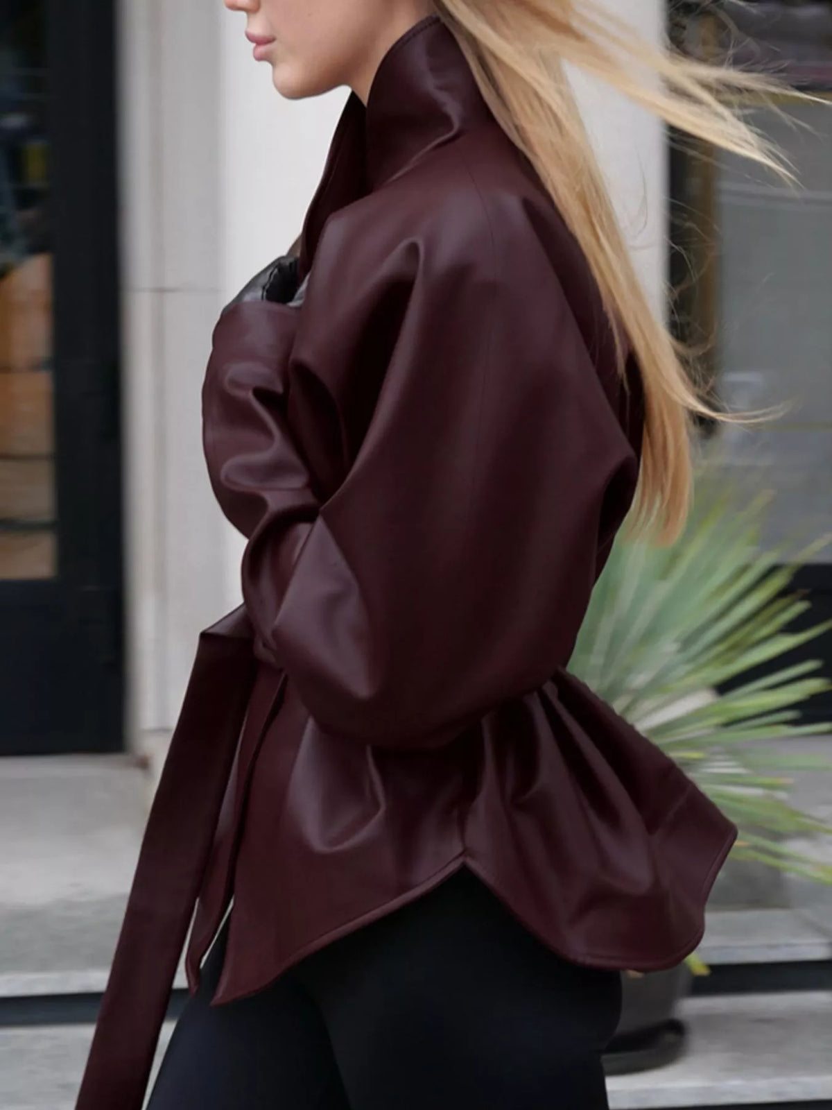 Women's faux leather jacket with stand collar and belt from Trendsi, featuring a sleek, stylish design.