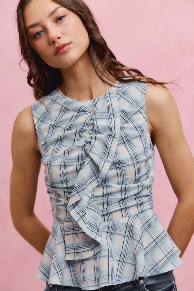 Plaid sleeveless ruffle peplum top from Plush Fashion Hub, featuring a stylish checked design and feminine ruffle details.
