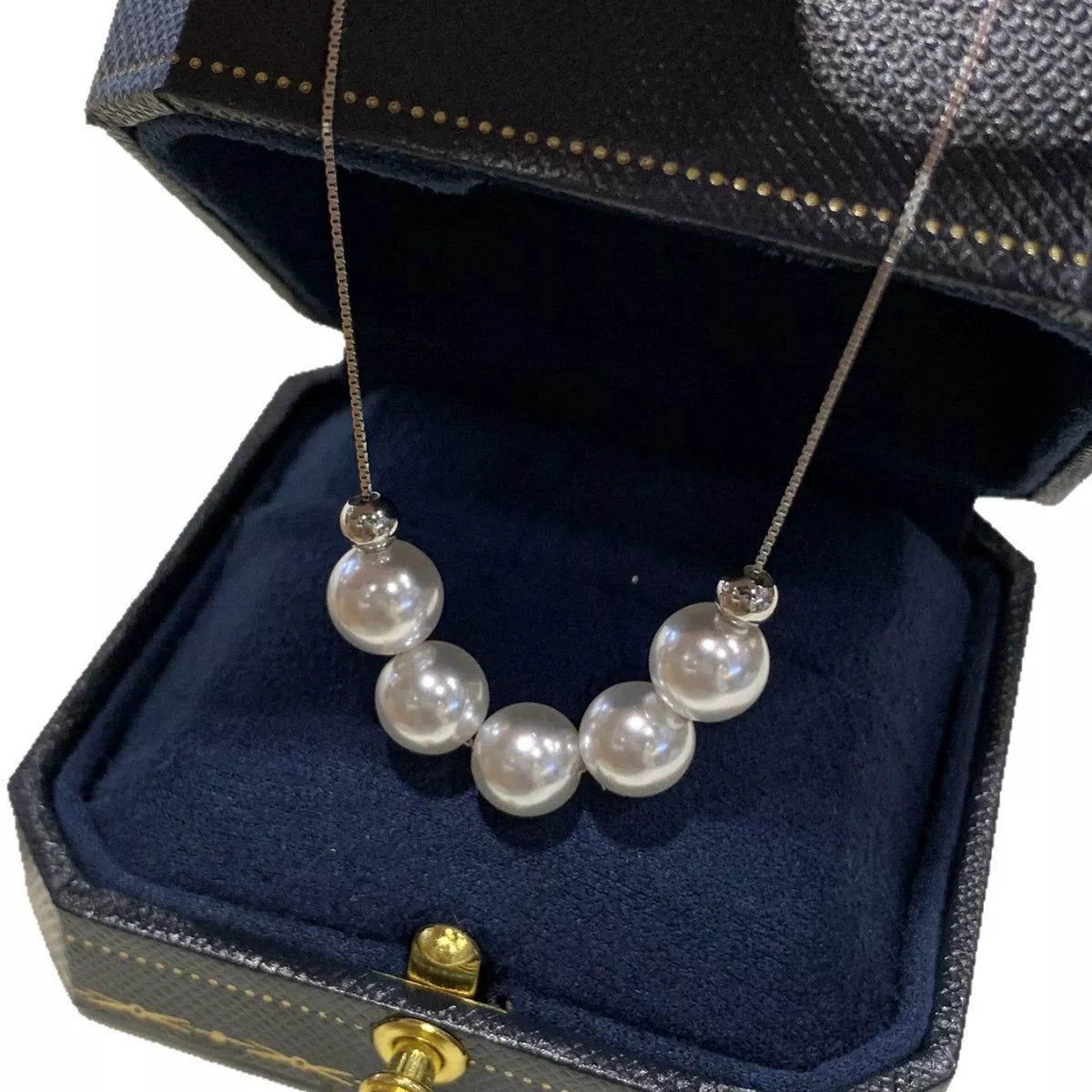 Adjustable pearl necklace with white pearls and silver clasp, stylish jewelry by Plush Fashion Hub.