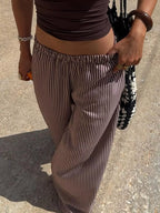 Striped wide-leg pants from Trendsi featuring a tied waist and relaxed fit, perfect for casual or stylish outfits.