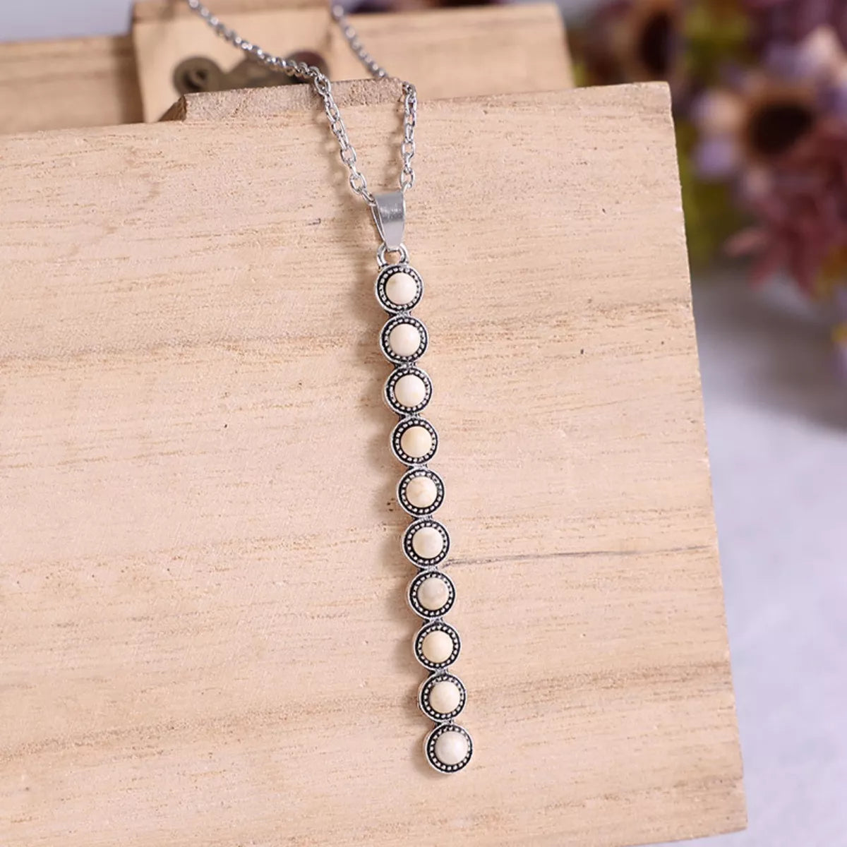 Vintage style beaded bar necklace from Plush Fashion Hub, featuring colorful beads on a delicate chain.