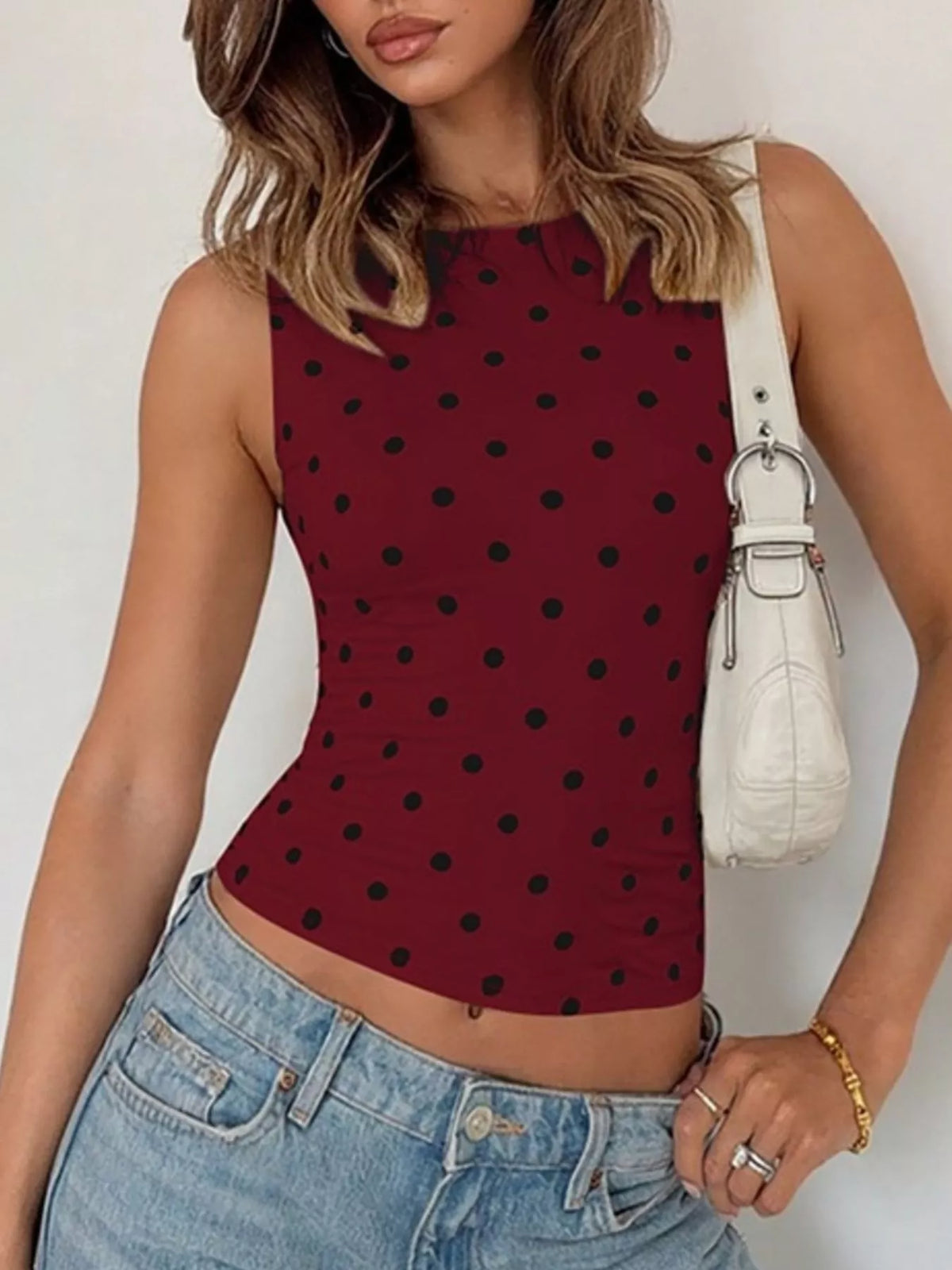 Polka dot tank top by Plush Fashion Hub featuring a sleeveless design and classic black and white polka dot pattern.