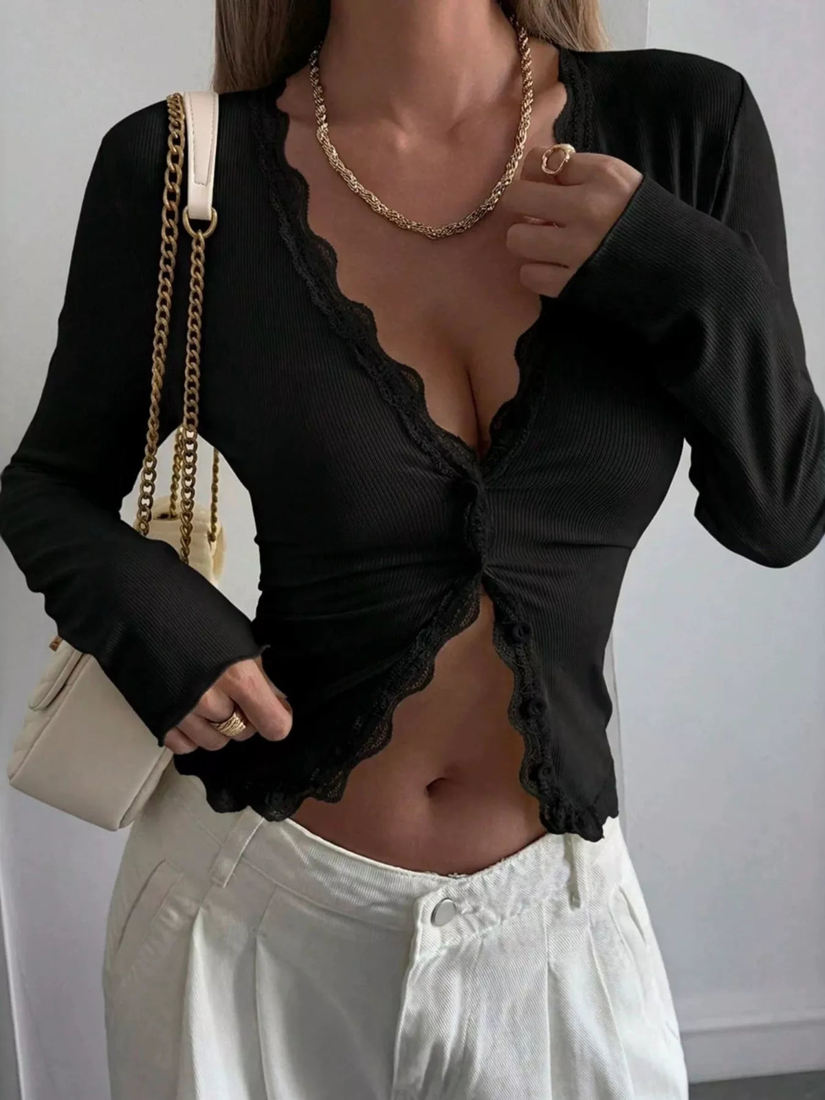 Ribbed long sleeve blouse with lace trim and V-neck, stylish trendy blouse in neutral fabric, perfect for casual or dressy wear.