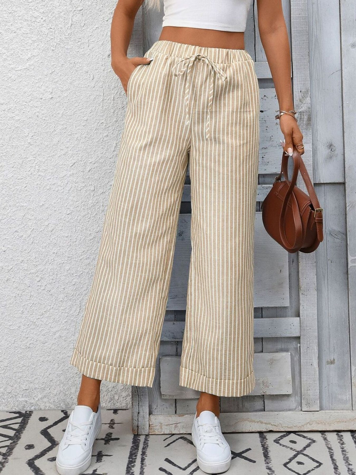 Women’s striped wide-leg drawstring pants with pockets by Plush Fashion Hub, featuring a relaxed fit and stylish design.