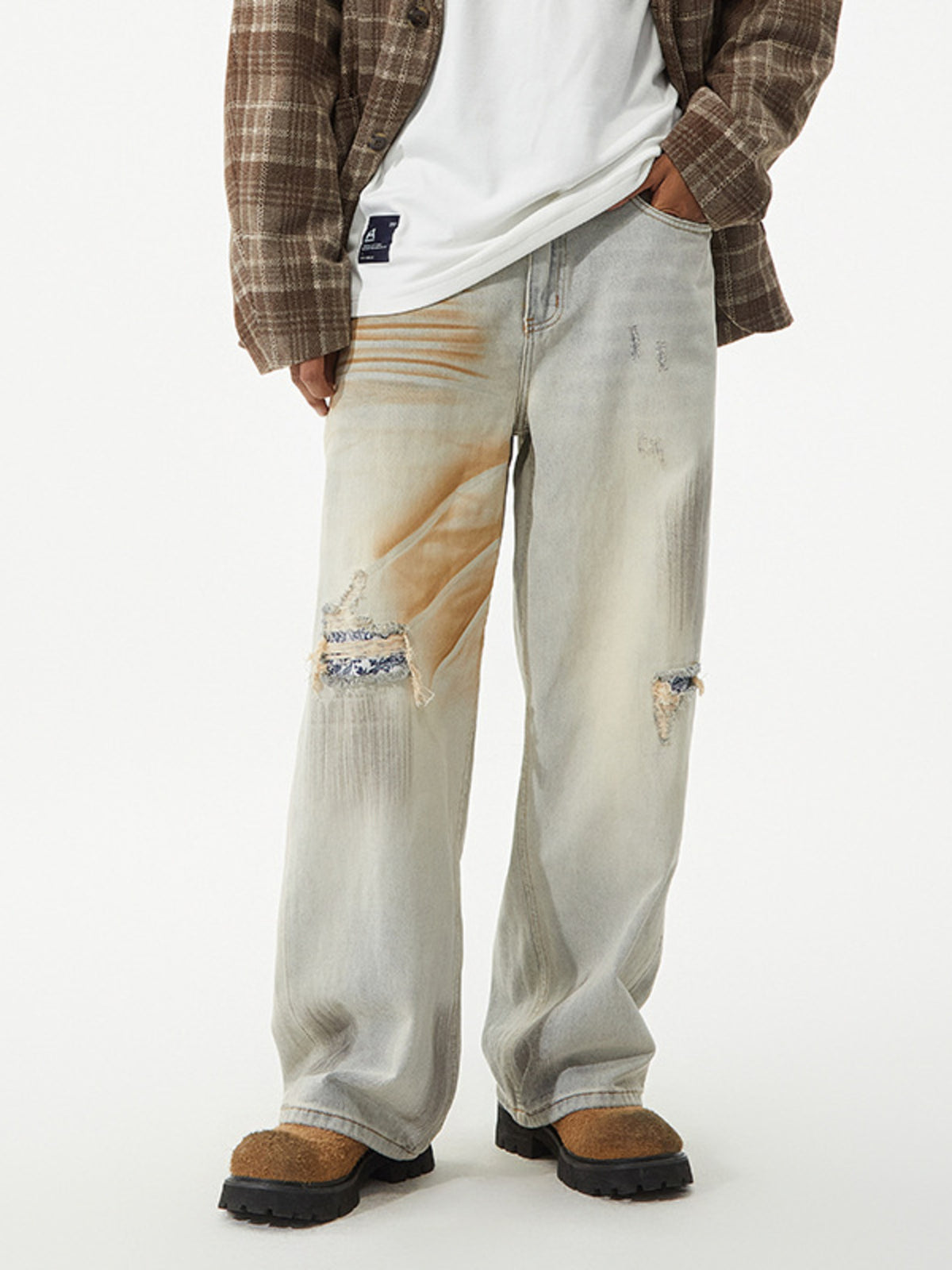 Men's distressed wide leg jeans by Plush Fashion Hub, showing the ripped details and relaxed fit on a model.
