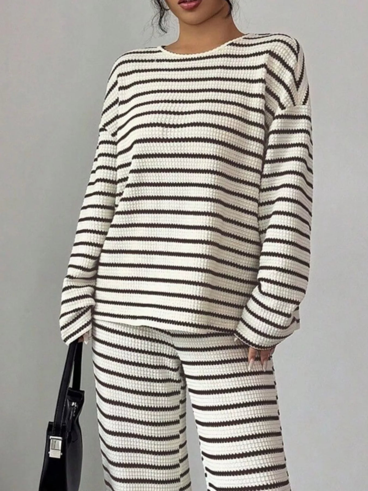 Striped knit dropped shoulder top and pants set by Trendsi, featuring a relaxed fit and casual style, shown in a coordinated outfit.