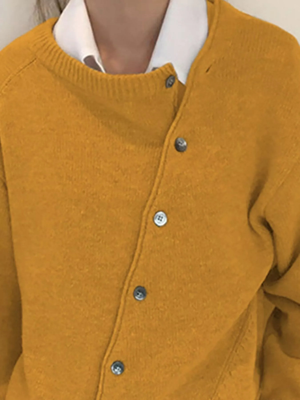 Asymmetric button-down sweater by Trendsi featuring a stylish, modern design with unique button placement and cozy knit fabric.
