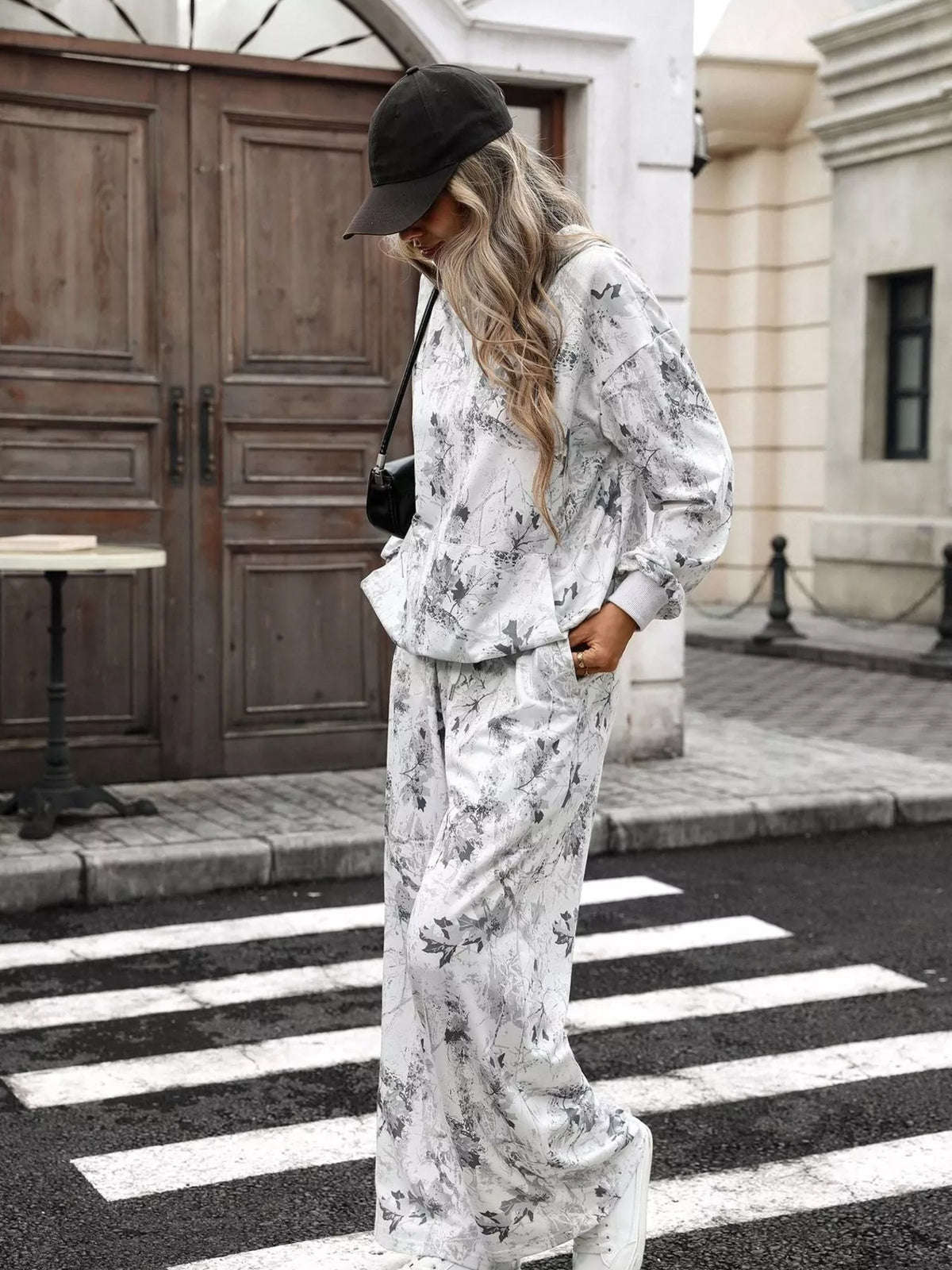 Printed long sleeve hoodie and pants set by Trendsi, casual loungewear with colorful graphic design and comfortable fit.