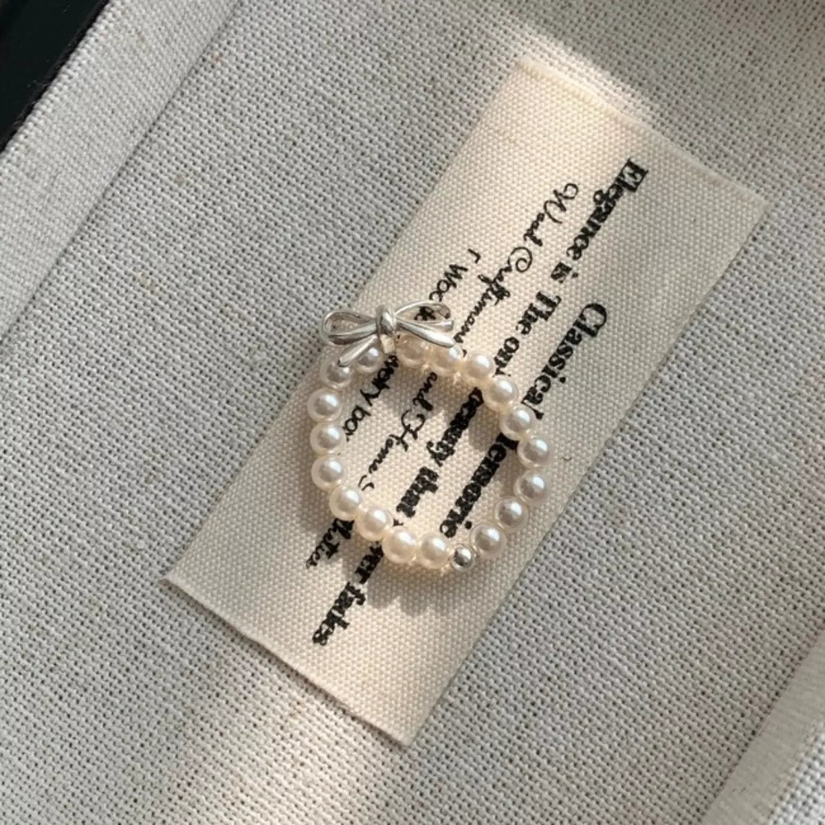Pearl beaded bow ring from Plush Fashion Hub, showcasing a delicate design with pearl accents and elegant craftsmanship.