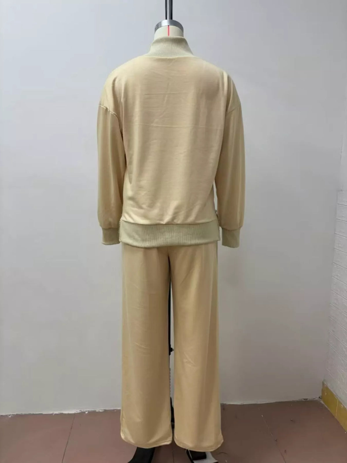 Trendsi turtleneck dropped shoulder top and matching pants set, featuring a cozy, stylish knit fabric in a neutral color.
