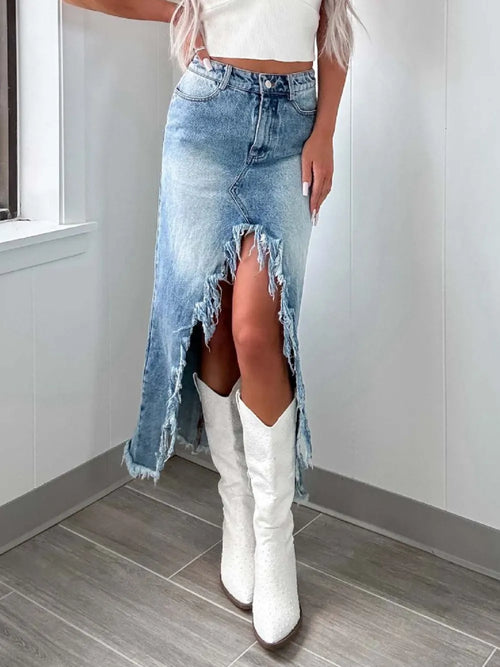 High-waist raw hem asymmetry denim skirt from Trendsi featuring distressed details and uneven hem for a stylish, casual look.
