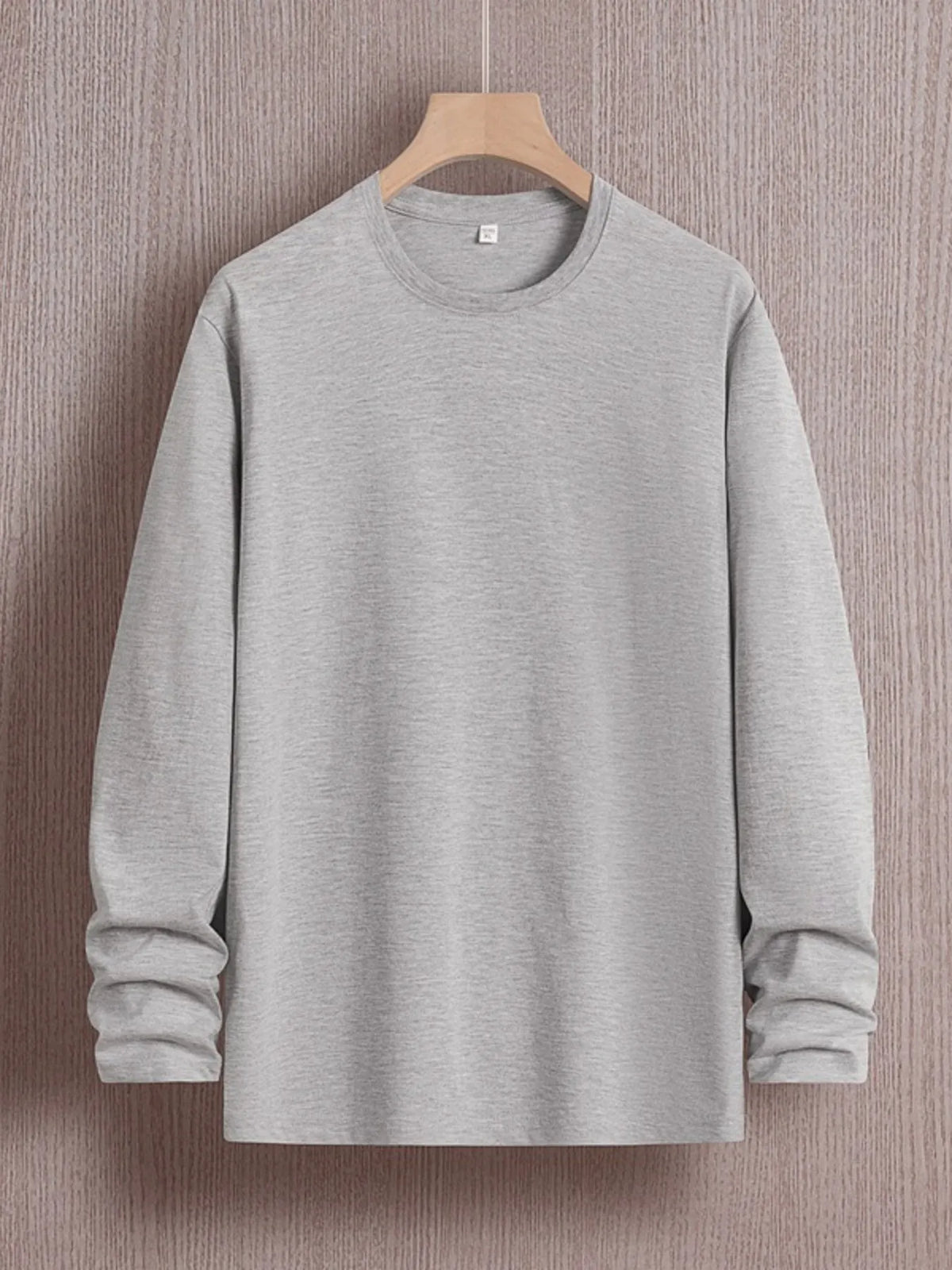 Plus size men's round neck long sleeve T-shirt by Trendsi, shown in a comfortable fit with soft fabric and casual style.