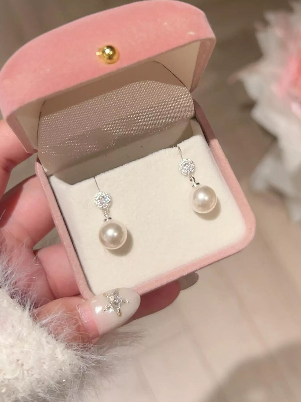 Elegant classic pearl drop earrings by Plush Fashion Hub featuring hanging pearls and gold-tone settings.