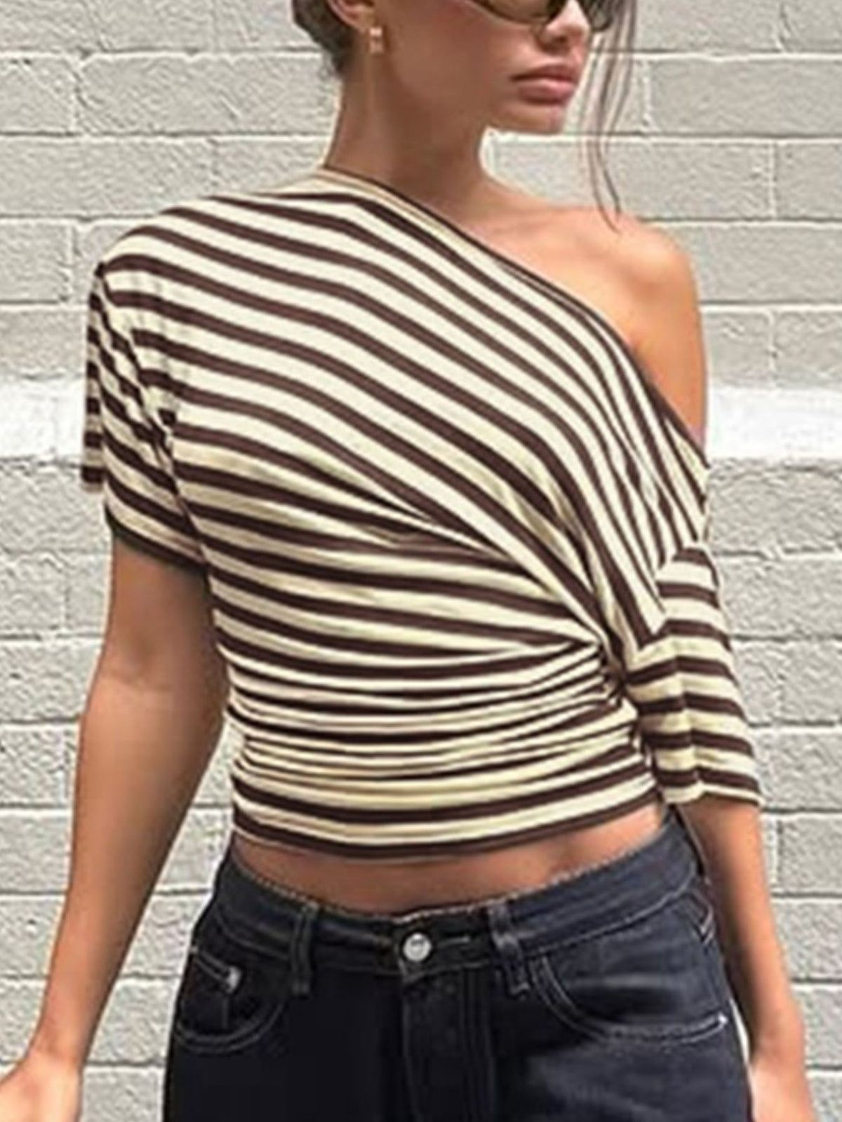 Women's asymmetrical striped one-shoulder T-shirt from Plush Fashion Hub featuring bold black and white horizontal stripes.