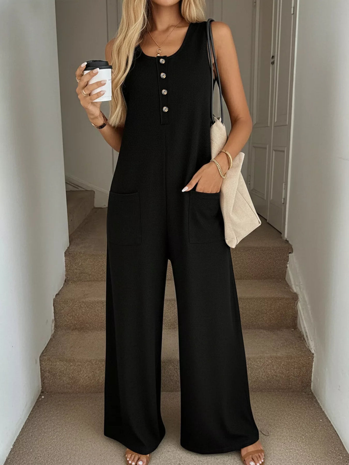 Sleeveless button-front wide-leg jumpsuit by Plush Fashion Hub, featuring a stylish design and relaxed fit.