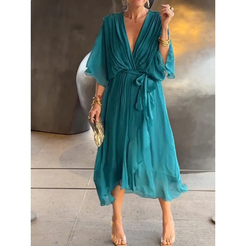 Plush Fashion Hub batwing sleeve V-neck midi dress with tied irregular hem, flowing fairy dress style, in soft fabric, shown on a model.