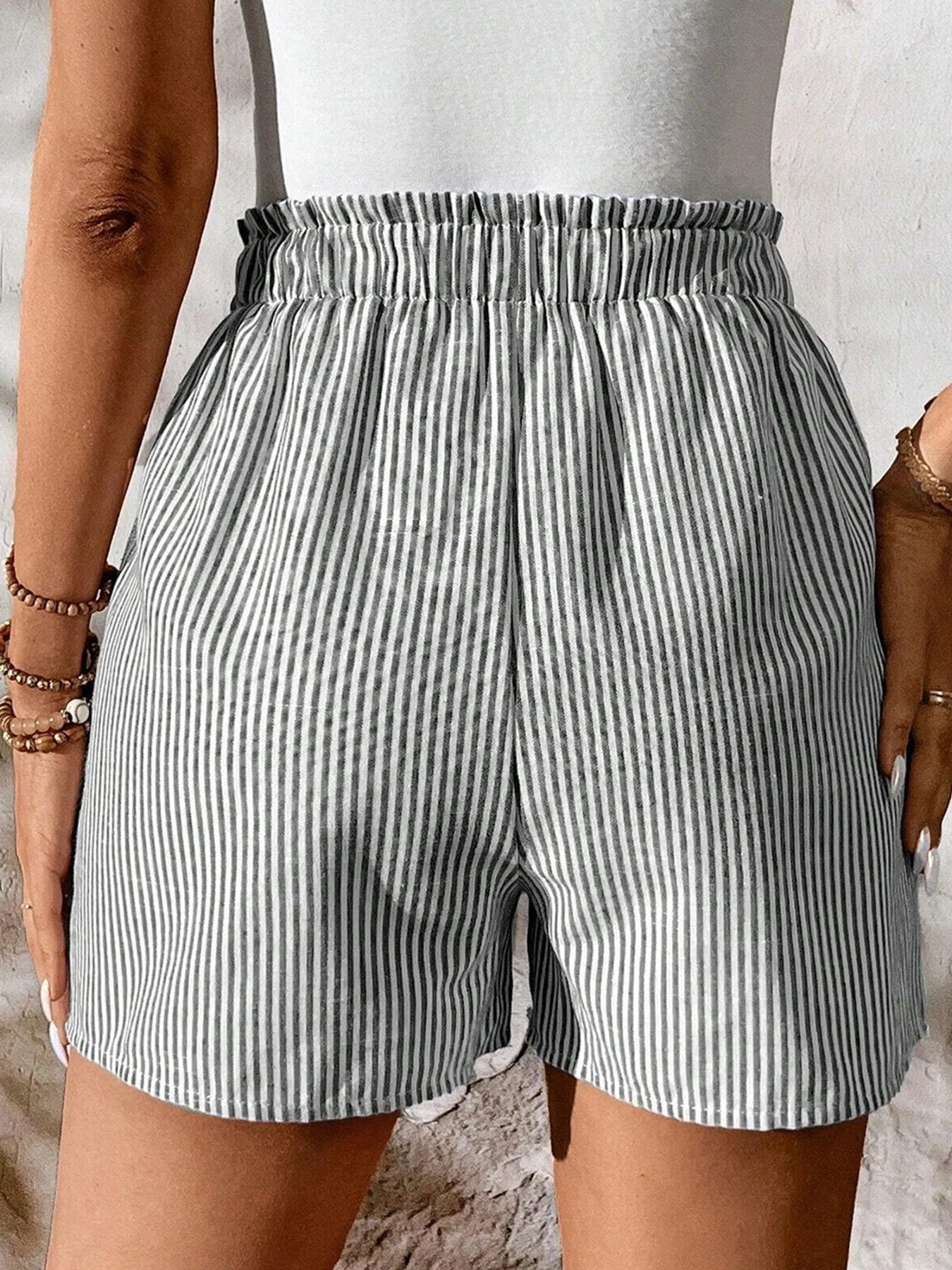 Women's striped elastic waist drawstring shorts from Trendsi, casual summer beachwear with comfortable fit and stylish design.