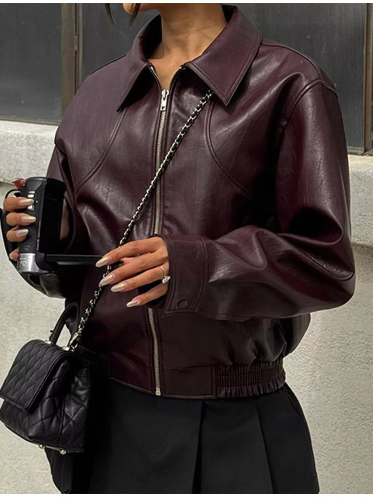 Women's leather belted jacket with shawl collar by Trendsi, featuring a stylish design and textured leather material.