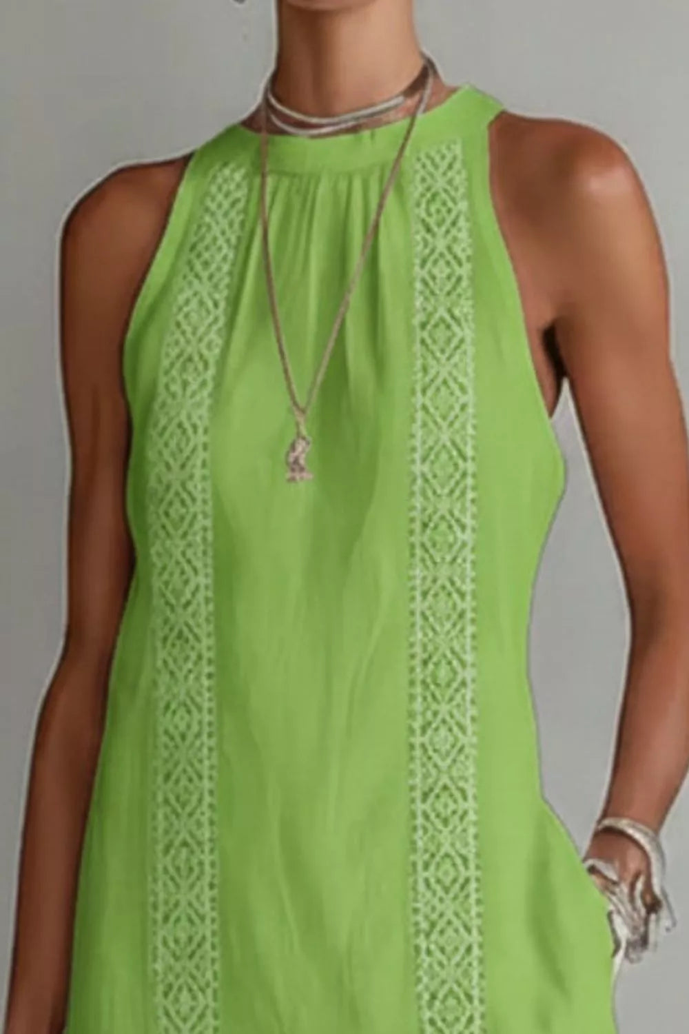 Women's sleeveless maxi dress with side slit and pockets, from Trendsi, shown in a flowing fabric with stylish design.