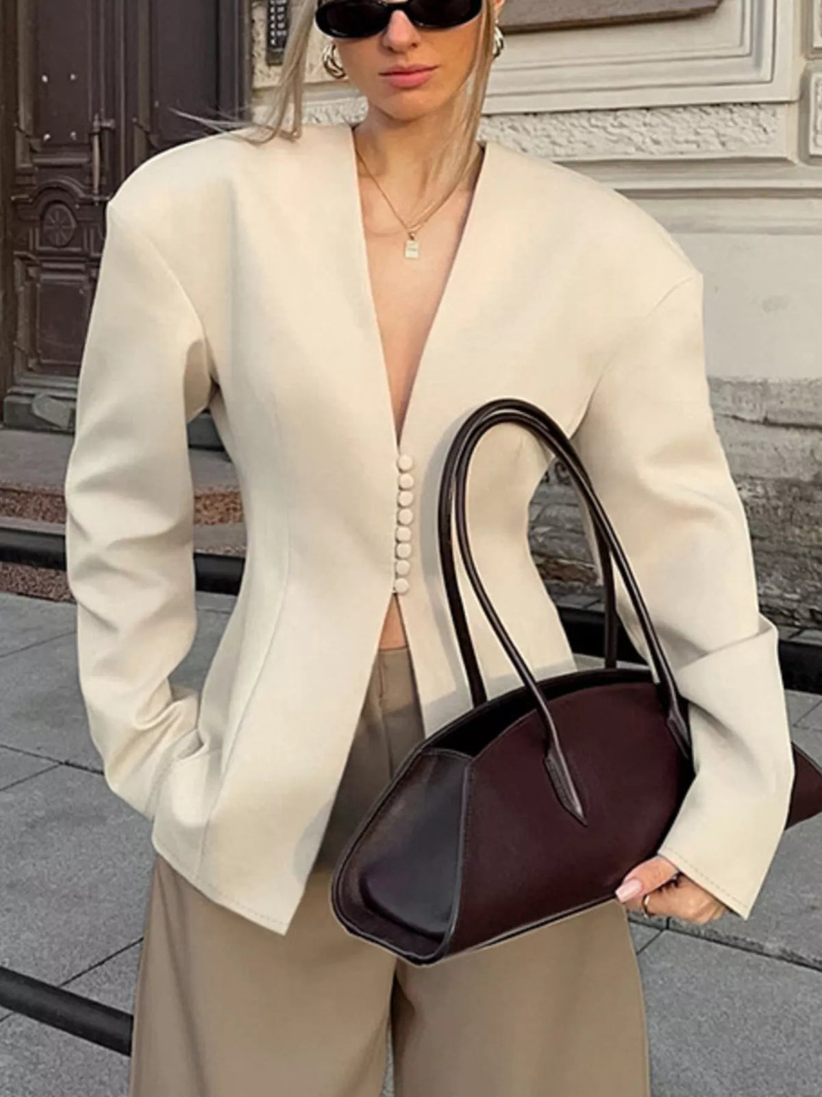 Trendsi women's V-neck button-up blazer with structured shoulders, tailored fit, and classic style, shown on a model.