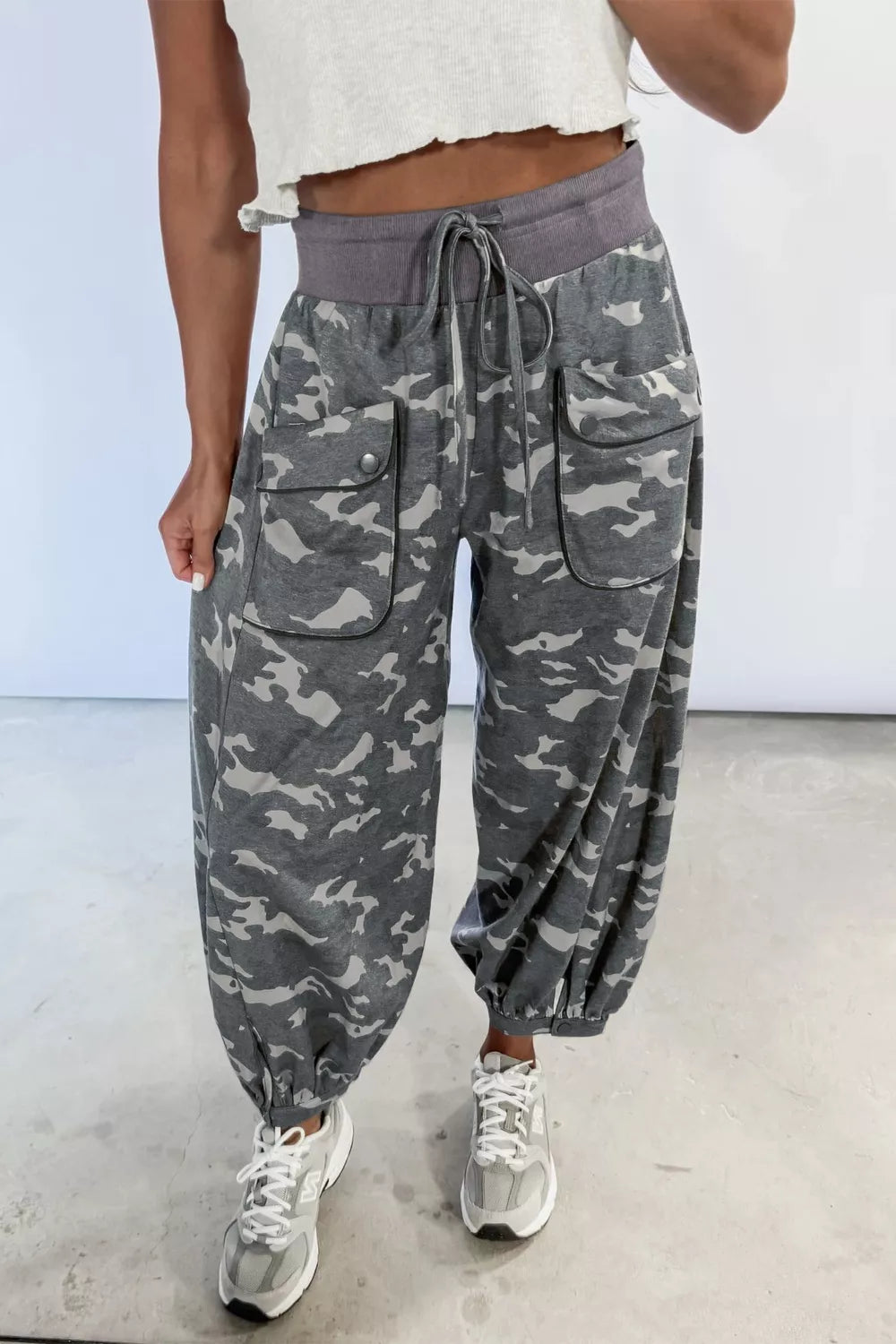 Multicolour camouflage cargo barrel pants with contrast waistband and drawstring from Plush Fashion Hub, featuring a relaxed fit and multiple pockets.