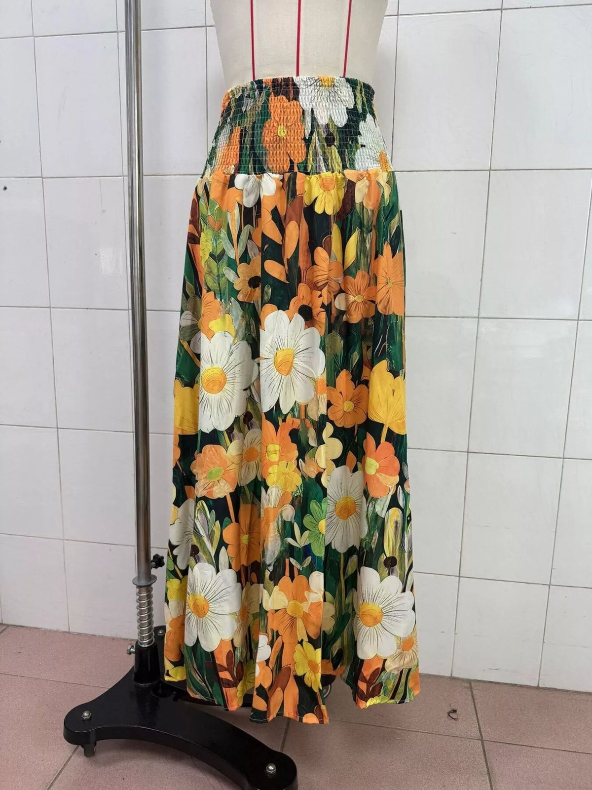 Floral print high-waisted maxi skirt from Trendsi, flowing fabric with vibrant flower patterns, full-length design.