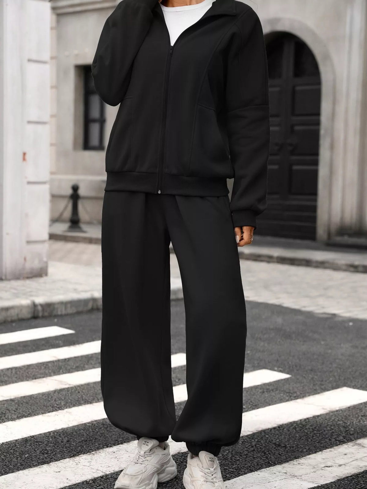 Women's zip-up long sleeve top and pants set by Trendsi, featuring a comfortable matching lounge wear outfit.