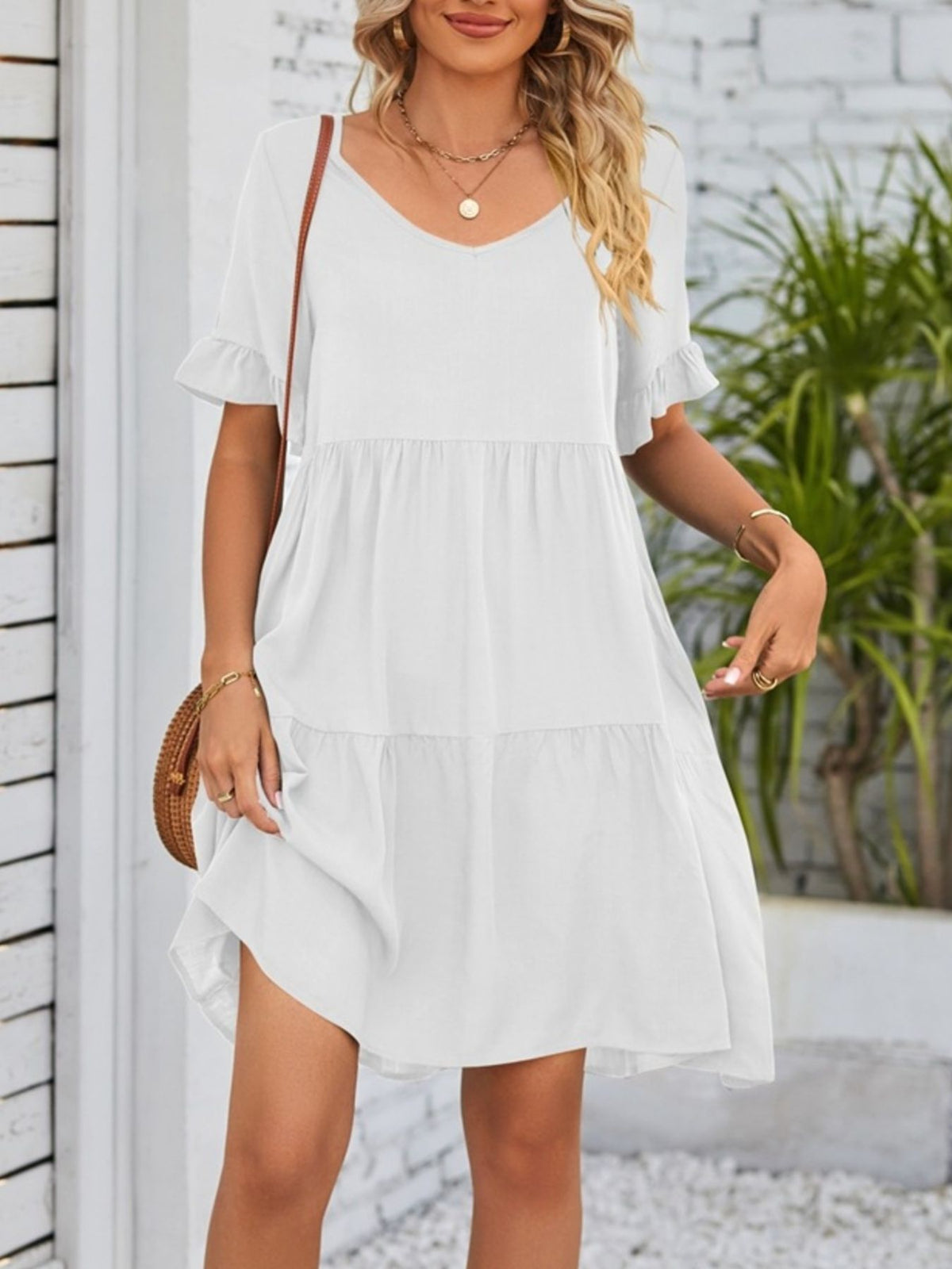 Lightweight rayon mini dress with ruffled sleeves, tiered design, and pockets from Plush Fashion Hub, perfect for casual summer wear.