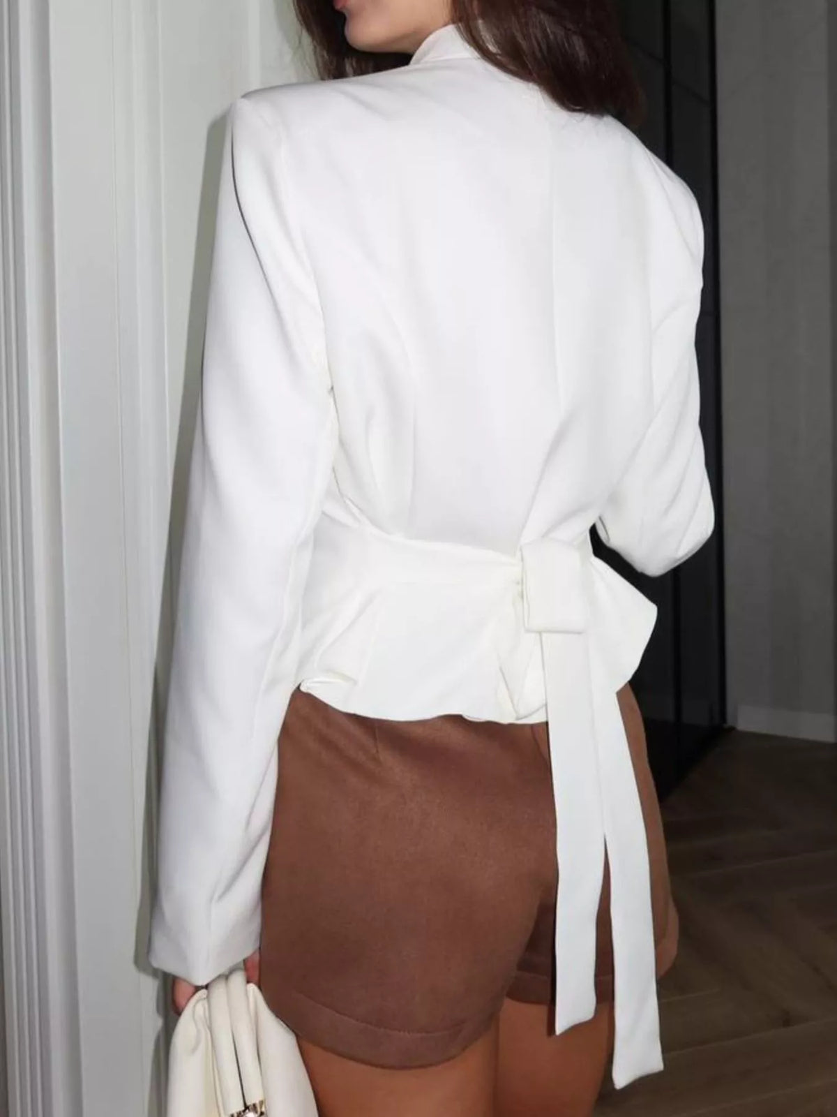Slim-fit asymmetric hem blazer by Trendsi, shown in black with tailored fit and stylish asymmetric front design.