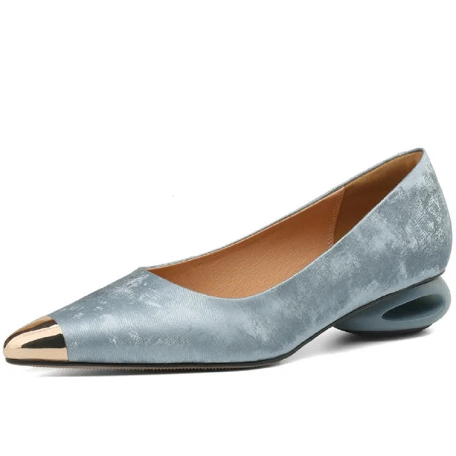 Blue, textured leather pointed-toe heels with a metallic gold cap toe and a unique, sculptural hollow heel.